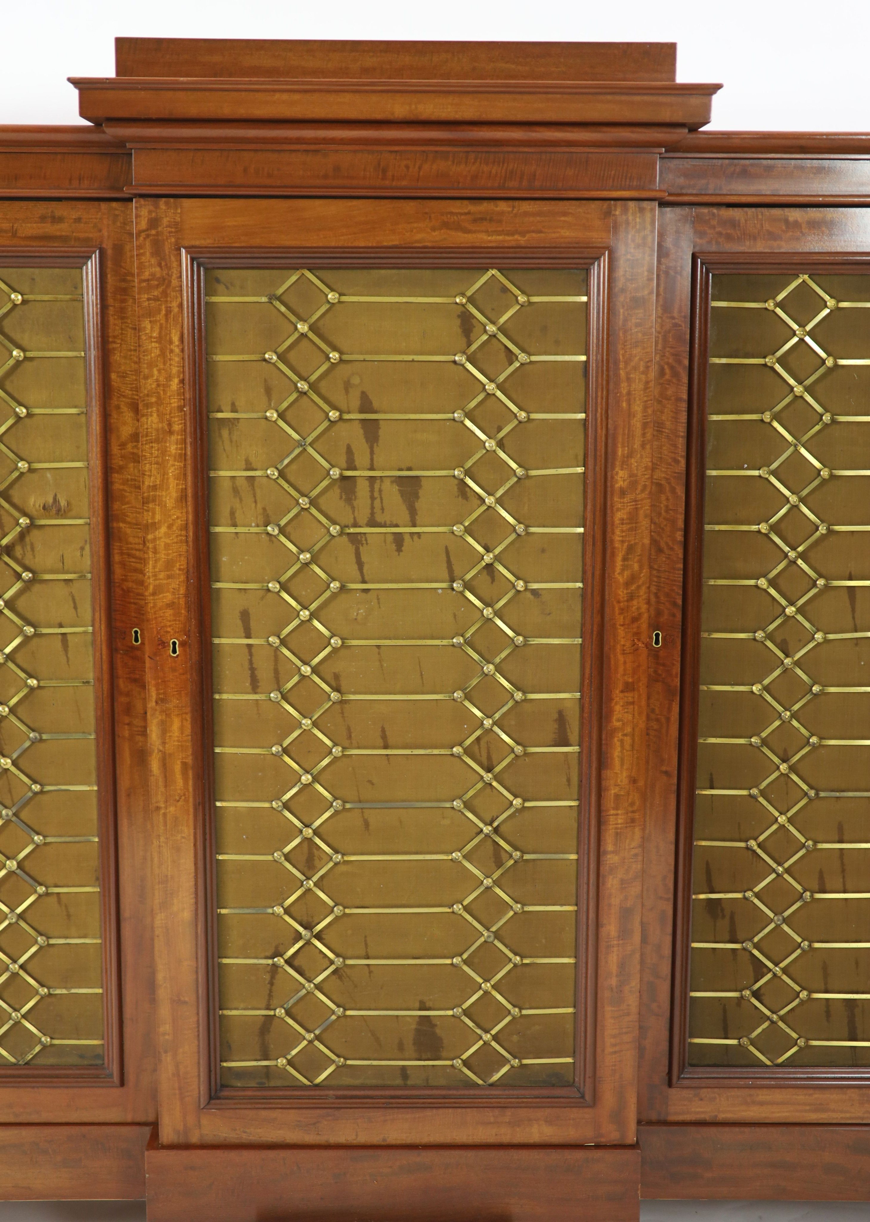 An early Victorian flame mahogany triple breakfront library cabinet, W.330cm D.51cm H.152cm